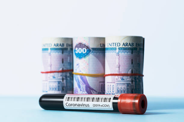 istock Coronavirus test tube and Emirati dirham 1213047977