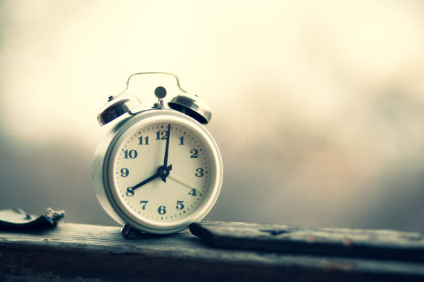 istock white vintage clock  on the desk 1213063746