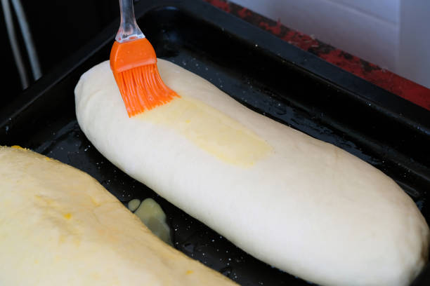 istock The process of lubricating a yeast dough with a beaten egg. 1213065065