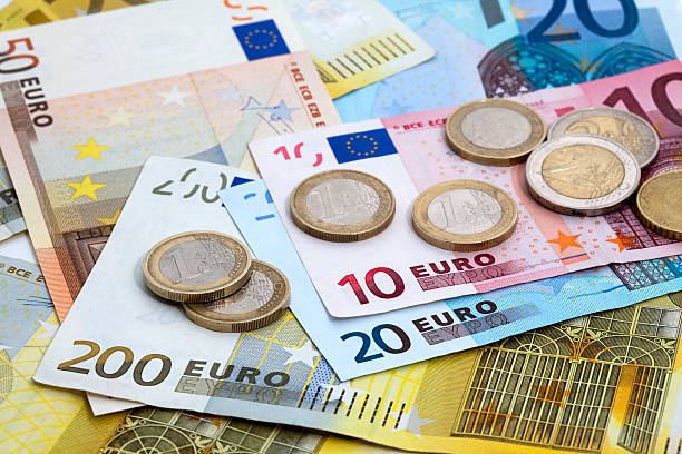 variety of denominations of euro coins and bills - euro stockfoto's en -beelden