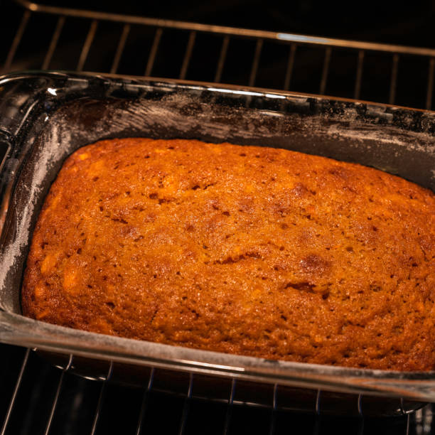 Home baked carrot cake cooling in a glass loaf pan