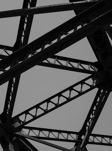 This is a black and white picture of the roof of a railroad bridge