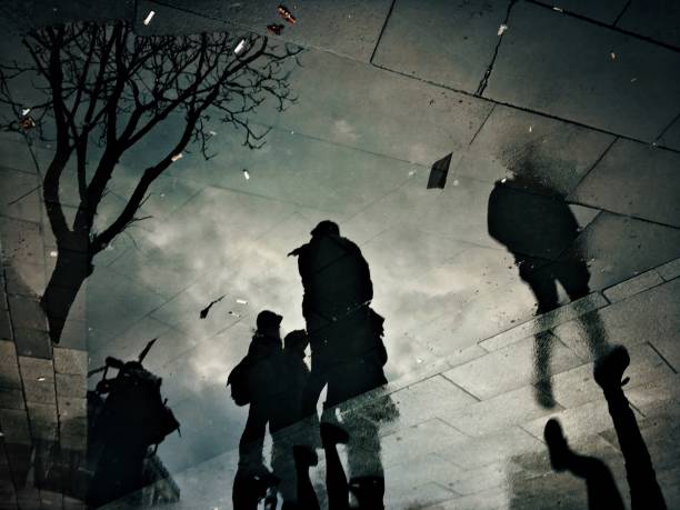 istock Reflection of the people on puddle 1213081309