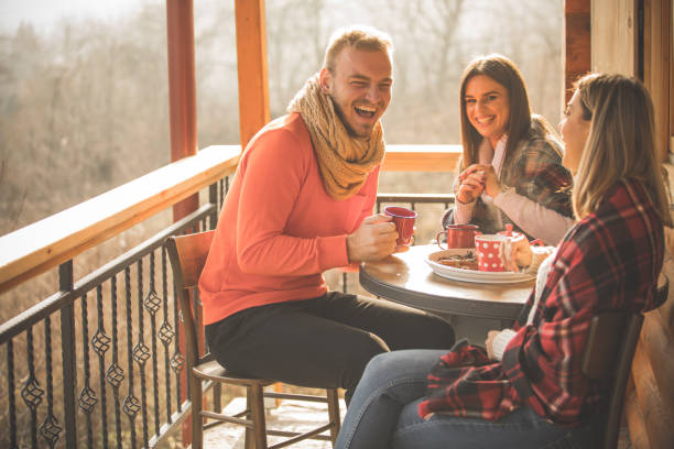 istock Three friends having a laugh and enjoying tea on their weekend getaway 1213087081