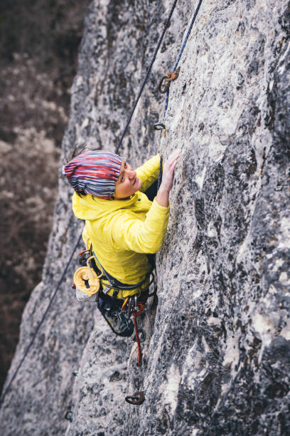 istock Woman climbs a rock. 1213087201