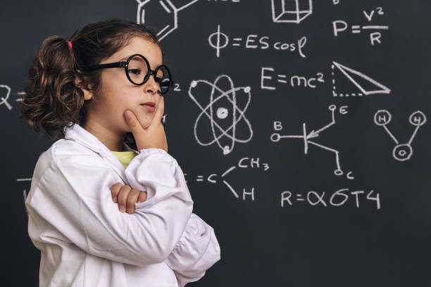 istock pensive little girl scientist in lab coat 1213087472