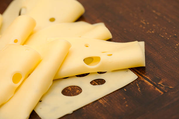 スライスのチーズ - swiss cheese ストックフォトと画像