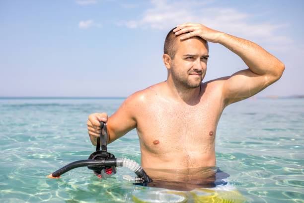 istock Young men free diving 1213089942