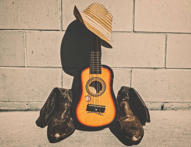 istock Cowboy boots, and guitar. 1213091231