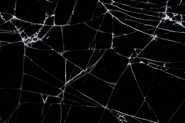 istock cracked glass isolated on a black background. 1213092822
