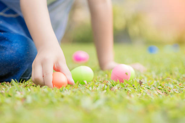 istock Little boy hunting for egg in spring garden on Easter day. 1213094006