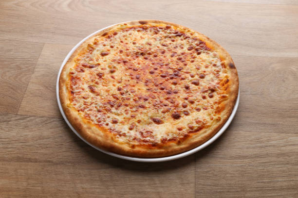 istock Margherita pizza with vegetables on a wooden background 1213097008
