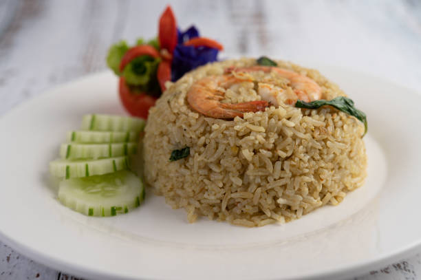 istock Shrimp fried rice on a white plate consisting of tomatoes and cucumbers. 1213100846