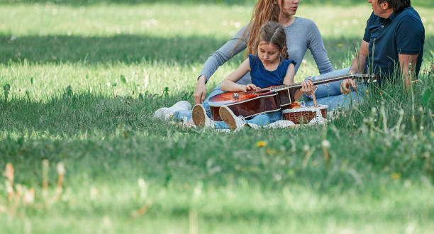istock parents with small two children on the lawn on a spring day 1213100869
