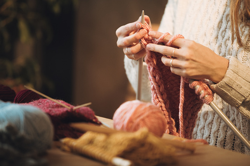 Close up on woman's hands knitting