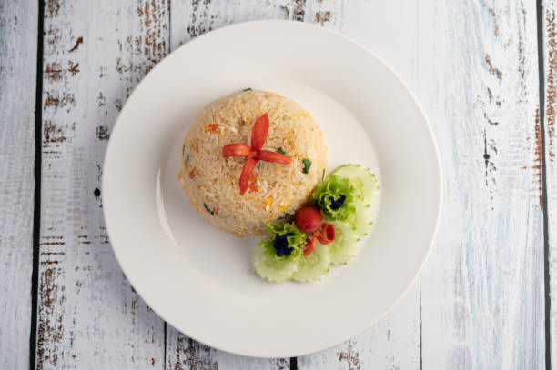 istock Fried rice with eggs in a white plate on wood background. 1213101124