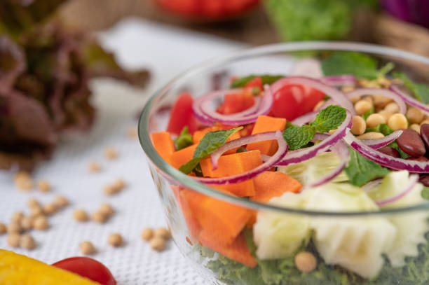 istock Fruit and vegetable salad in a glass cup on a white ground. Selective foucs 1213103759