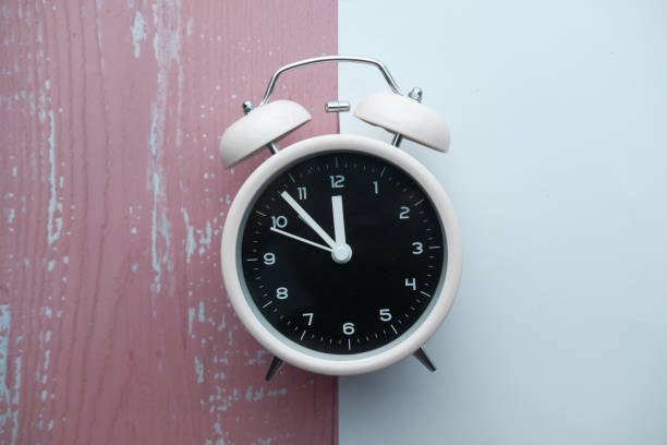 istock vintage alarm clock on pink background. Top view. Flat lay 1213110908