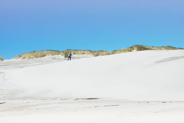 istock Child with Sand Board in Dunes 1213111420