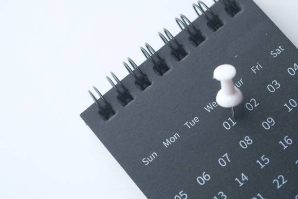 Cutout calendar symbol on post it notes on blue background. Horizontal composition. Reminder and calendar concept.