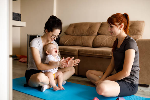 istock Young mother playing with her baby while home training 1213119427