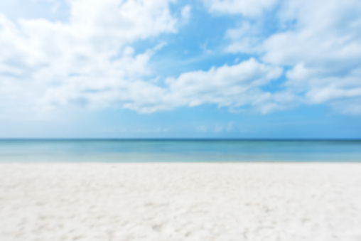 Empty white sand beach and sea with clear sky blurred abstract background