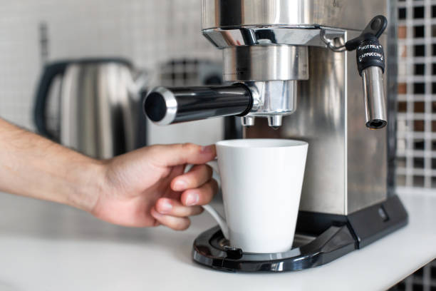 istock Guy prepare delicious aromatic coffee in a coffee machine. A simple way to make coffee 1213122658