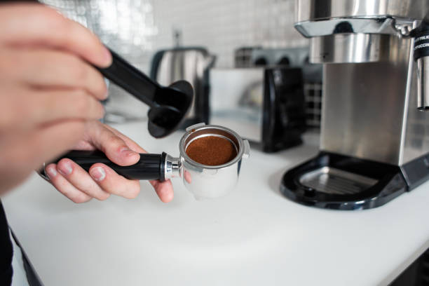 istock Guy prepare delicious aromatic coffee in a coffee machine. A simple way to make coffee 1213122733