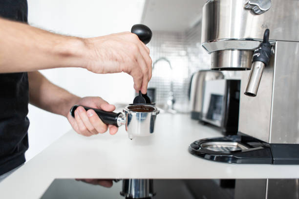 istock Guy prepare delicious aromatic coffee in a coffee machine. A simple way to make coffee 1213122842