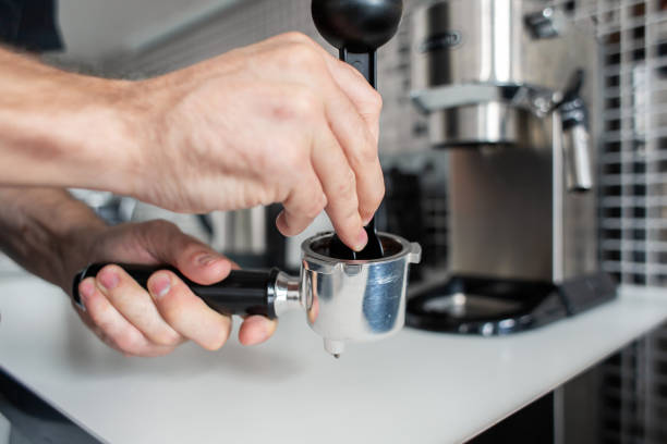 istock Guy prepare delicious aromatic coffee in a coffee machine. A simple way to make coffee 1213122934