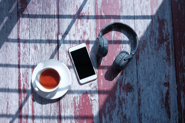 istock top view of smart phone ,tea and headphone on table 1213124433