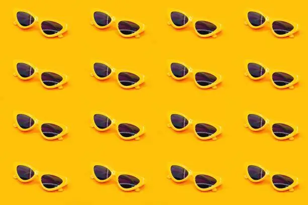 Yellow sunglasses set.The sunglasses on a orange background,pattern fashion wallpaper.