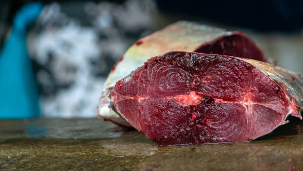 close up view of cut tuna fillet on counter top at street market, copy space. - tuna steak tuna prepared ahi meat imagens e fotografias de stock