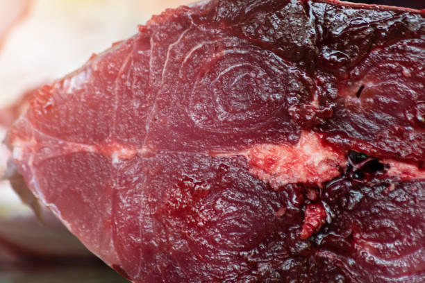 close up view of cut tuna fillet on counter top at street market, copy space. - tuna steak tuna prepared ahi meat imagens e fotografias de stock