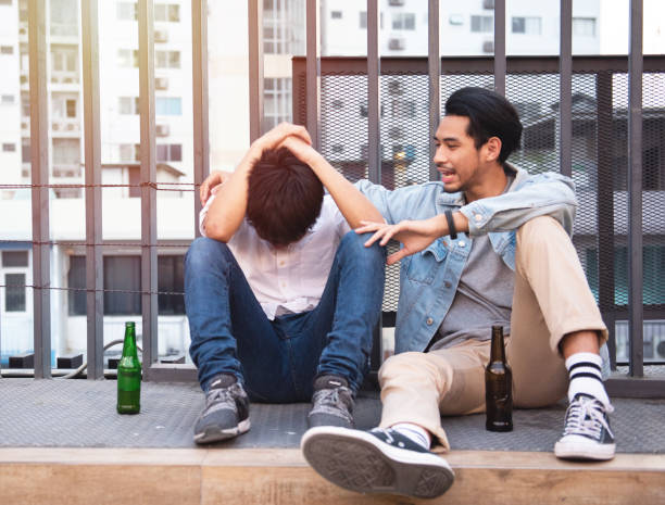 Two friends drink beer in a pub on the street. People, men, leisure, friendship and holiday concept - happy male friends drinking beer in bar or pub outside. Two friends drink beer in a pub on the street. People, men, leisure, friendship and holiday concept - happy male friends drinking beer in bar or pub outside. sobriety stock pictures, royalty-free photos & images