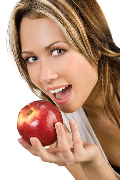istock Beautiful young woman biting a red apple. 121312891