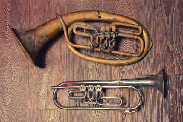 istock old brass wind instrument and horn  on a wooden background 1213129879