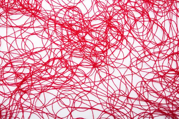 Photo of red threads on white background