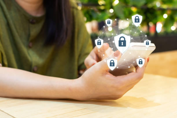 istock Data protection and security important information in your mobile phone, Woman hand using smartphone and icon key on shield 1213132398