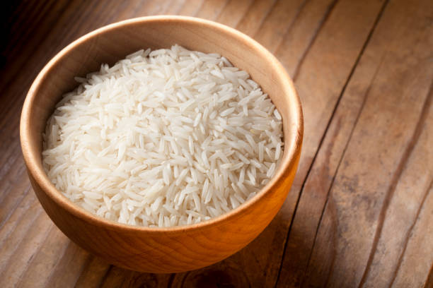 Basmati rice grains in wooden bowl
