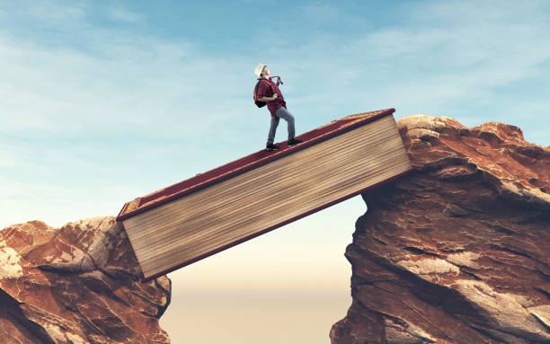istock Student running over a gap between mountains on a book . Overcome any obstacle . 1213135495