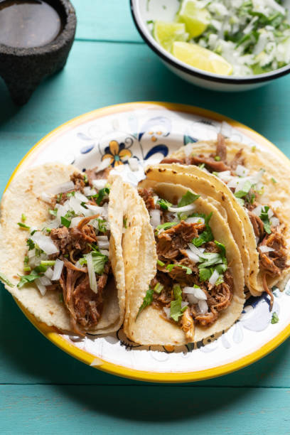 istock Mexican slow cooked lamb tacos also called barbacoa on turquoise background 1213135686