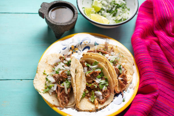 istock Mexican slow cooked lamb tacos also called barbacoa on turquoise background 1213136699