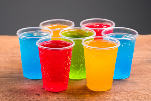 Colorful soft drinks in plastic cups, many kinds and color of sweet cold drinks