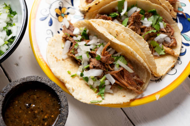 istock Mexican slow cooked lamb tacos also called barbacoa on white background 1213138309
