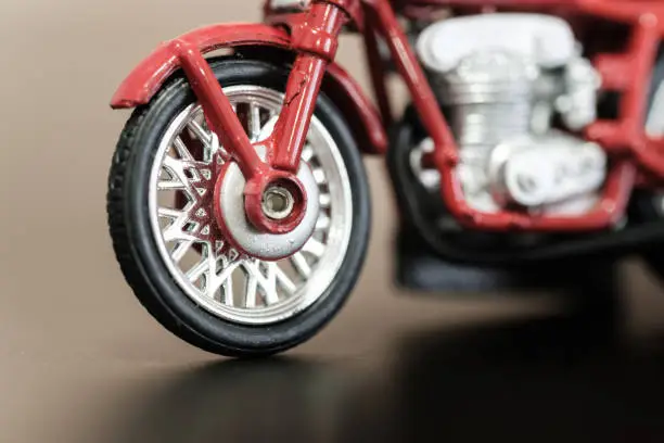 Photo of vintage style red color motorbike toy closeup view