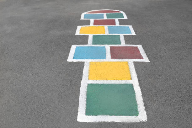 Multicolored classics painted on the road. Game for children.