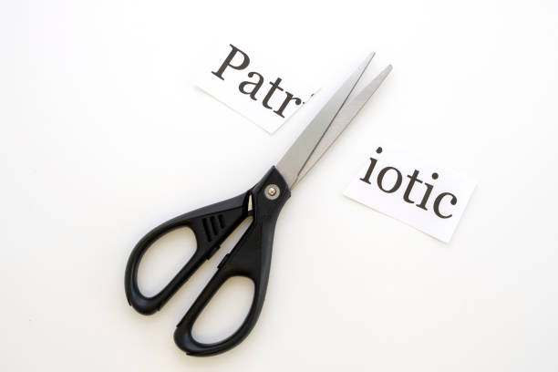 istock scissors cut a sheet with the inscription Patriotic 1213140284