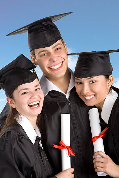 istock Three smiling graduates at the blue sky. XXXL 121314250