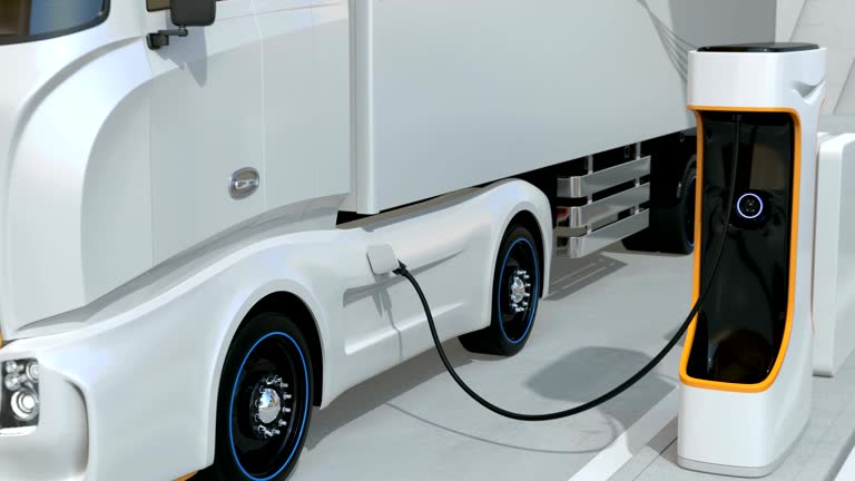 Generic design blue Heavy Electric Trucks charging at Public Charging Station. The charging station